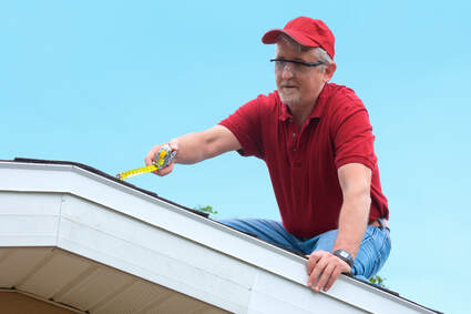 A roofer estimating a patch size over a roof in Avondale Arizona.