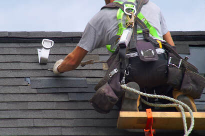 A roofer working on a patch for a roof top.